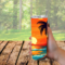 This photo shows a woman holding the beach sunset tumbler outdoors with trees in the background. Perfect for your travels, beach, camping
